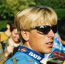 A blonde haired man wearing sunglasses.