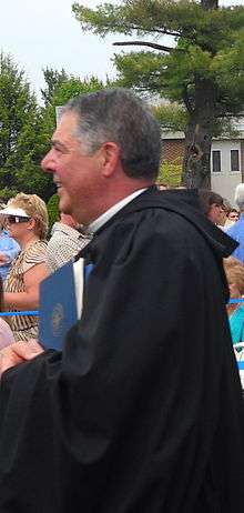 Profile of Father Jonathan walking into the Commencement exercises at Saint Anselm College