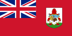 Red flag with Union Flag as top-left quarter and crest on right side.