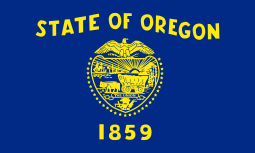 A navy blue flag with gold lettering and symbols; "STATE OF OREGON" is written above a shield, which is surrounded by 33 stars. "1859" appears underneath the shield.