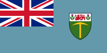 A sky blue flag with the Union Jack in the upper-left-hand corner, and a coat of arms on the right.