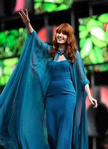 Florence Welch wearing a long blue dress.