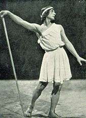 male ballet dancer in ancient Greek costume striking a pose