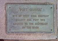 A metallic plaque with the words "Fort Orange: Site of West India Company Colony 1624, was located to the southeast by the river."