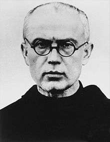 Priest wearing round-rimmed glasses