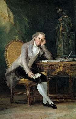 Portrait of a man seated at a desk, cheek resting on his hand
