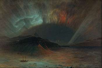 Red and green northern lights over seascape