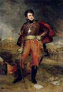 Painting shows a hatless man in a hussar uniform holding a sword in his right hand. His left hand rests on his hip.
