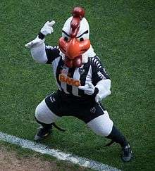 A person costumed as a rooster in a football uniform