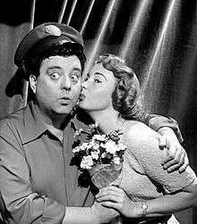 Alice Kramden kissing Ralph after he gives her a bouquet