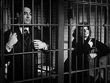 Cary Grant and Katharine Hepburn in adjacent jail cells
