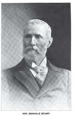 B&W photograph of a grey haired man with a full beard.