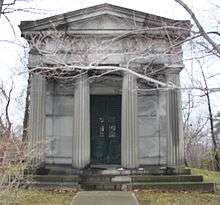 A mock Greco-Roman style mausoleum, about the size of a small house