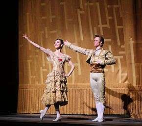 A photograph of Seo and Jared Matthews with their arms extended during the curtain call for Don Quixote on 17 May 2014