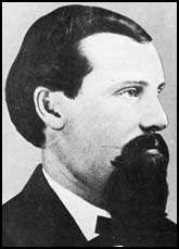 B&W image of a man with short hair and a long goatee beard