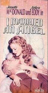 video cover of I Married an Angel; depicts Jeanette MacDonald, as a glamorous angel, holding Nelson Eddy (as a businessman) in her arms