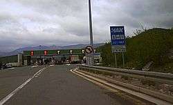 Six lane toll plaza with variable traffic signs placed above the toll plaza gates