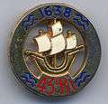 Round military insignia with a sailing ship in the center and 1638 at the top