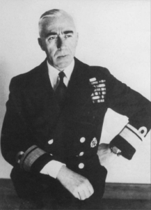 Seated middle-aged man in naval uniform, looking right