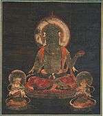 Frontal view of a seated figure with halo flanked by two small figures.