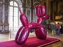 Balloon Dog sculpture Magenta color by Jef Koons at the Palazzo Grassi