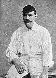 A man dressed in cricket whites