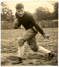 Guyon in his Tech uniform, posing in a running stance with a football