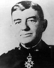 A black and white image of John A. Lejeune, a white male in his Marine Corps dress blue uniform. A medal is clearly visible around his neck. He is not wearing a hat.