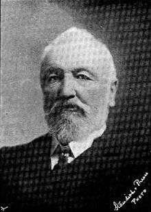 portrait photo of John Thomas Peacock, showing a grey-haired older man with full beard in formal clothes