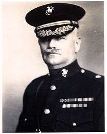 an image of a white male in his military uniform with a hat on and a mustache. Military style ribbons are clearly visible.