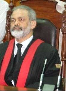 Seated man in judicial robes