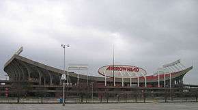 A bowl-shaped concrete structure. In the middle is an oval sign with "Arrowhead" written on it in red letters.