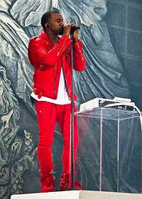 A picture of a man dressed in red singing