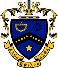 Coat of Arms of Kappa Kappa Psi. A blue shield is divided by a black chevron, on which ten gold stars are placed: five on the left side of the chevron, five on the right. On the upper-left side is a representation of the fraternity badge in gold and black. On the upper right are three black circles. In the lower half of the shield, there is a large gold star. The shield is capped by a bar of alternating blue and gold, over which rests a golden lyre. Decorative mantling of gold with blue surrounds the crest. Beneath the crest is a golden scroll, on which are written the Greek words "Alpha Epsilon Alpha."