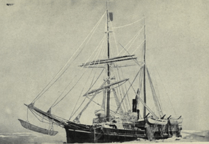 Two-masted sail-and-steam ship, with pennant flying from topmast, sails furled, lying stationary in a frozen sea