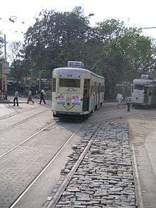 Two trams rounding a curve