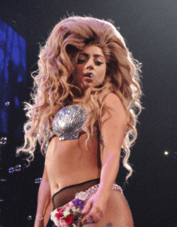 Lady Gaga performing in a seashell costume.
