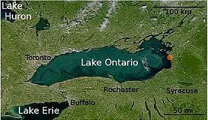 Satellite photograph of Lake Ontario. The cities of Syracuse, Rochester, Buffalo, and Toronto are labeled.