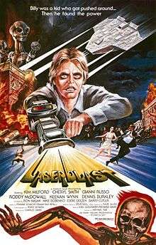 A film poster with a young man with a laser gun extended from his arm, shooting out the title "Laserblast". A tagline at the top reads "Billy was a kid who got pushed around... Then he found the power". The top left shows two extraterrestrial aliens on top of a burning building, opposite an extraterrestrial spacecraft. Below the burning building, people are seen running away on the street. Credits for the film appear below the title, and a skeleton on fire is at the bottom of the image.