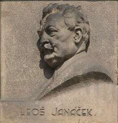 wall plaque with profile of a man's head; he is elderly with a moustache and a full head of hair