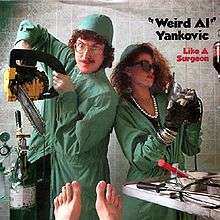 "Weird Al" Yankovic dressed as a surgeon holding a chainsaw in his hand, flanked by a woman dressed like Madonna and wearing sunglasses, also in surgeon's uniform.