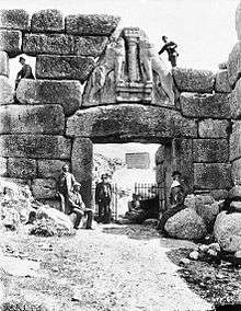 Black and white photograph of the Lion Gate at Mycenae.