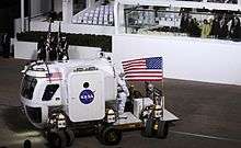 President Obama, Michelle Obama and Vice President Biden watch as NASA's Lunar Electric Rover demonstrates how its 12 wheels can pivot independently.