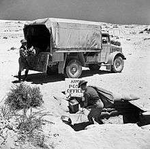The mail being unloaded from an Army Post Office lorry at one of the many post offices in the Western Desert, 16 July 1941