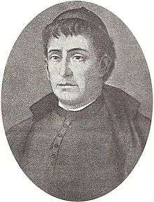 Black and white oval portrait of a priest. The image is focused on his face, looking to the left.