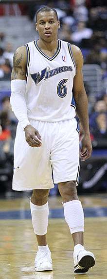 A full body shot of Maurice Evans, wearing a Washington Wizards uniform and a white armband, pictured in 2011