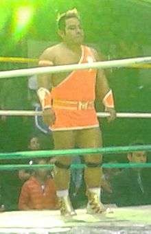 A color photo of Máximo Sexy standing in a wrestling ring