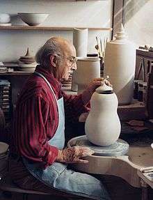 The artist works on a lidded pot in his studio in 1992.