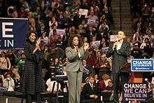 Michelle Obama, Oprah Winfrey and Barack Obama on stage at a campaign rally.