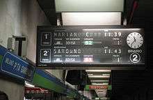 Split-flap display at Milano Porta Garibaldi showing an S2 train to Mariano Comense as the next departure.